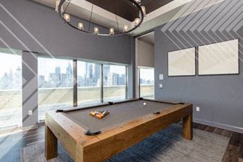 a pool table in a room with a large window